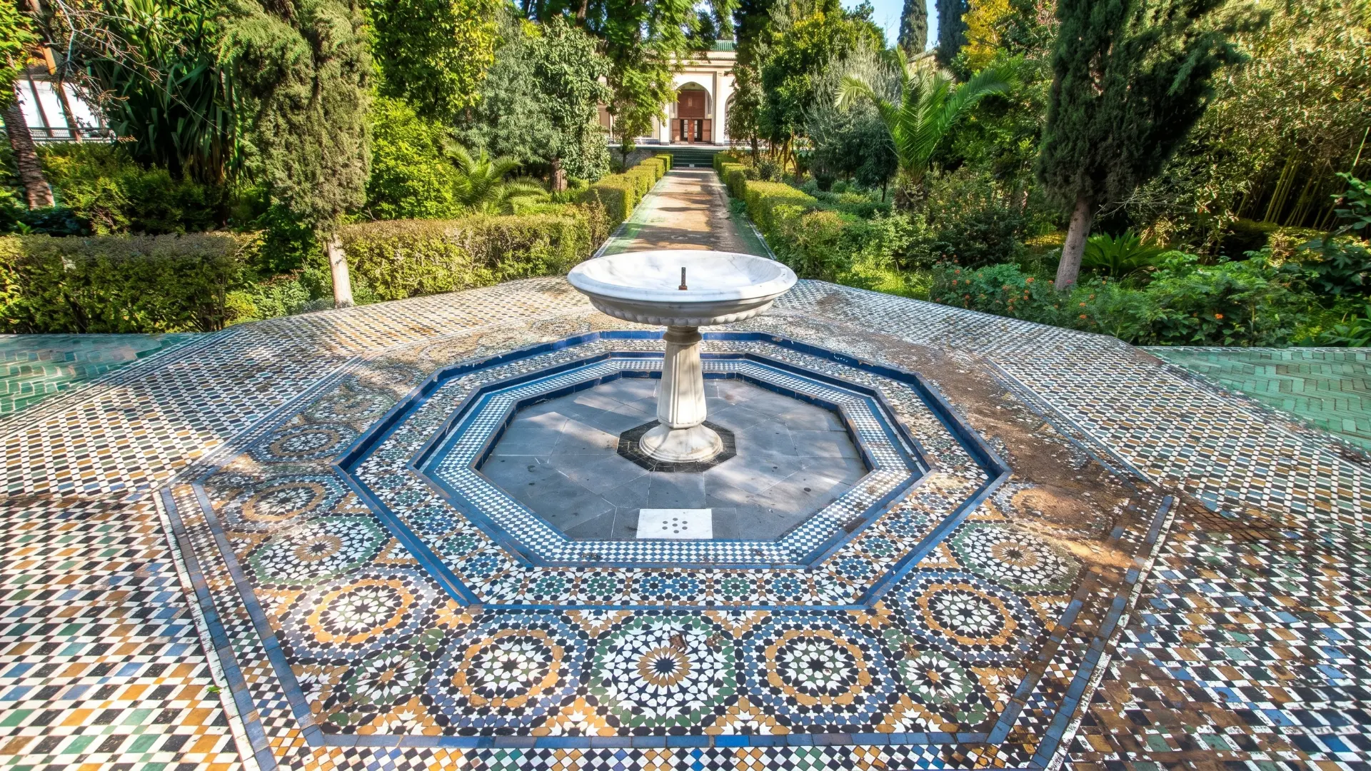 Dar Batha Museum Fountain Fez | Stunning Zellige Mosaic Tile Art Morocco Colorful geometric zellige mosaic fountain with intricate star patterns and ornate arch in the gardens of Dar Batha Museum, Fez Morocco