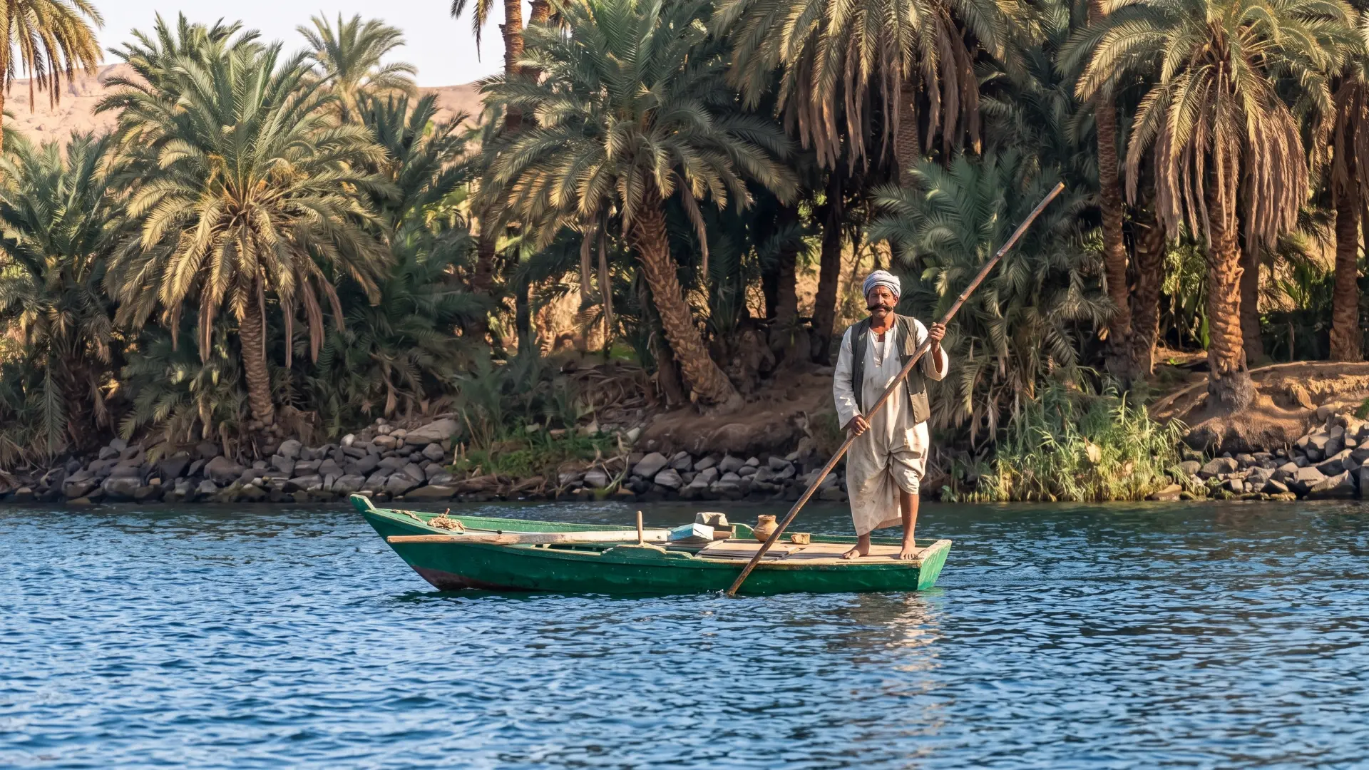 Fisherman on the Nile River Egypt | Traditional Nile Fishing Traditional fisherman working on the Nile River in Egypt with a dahabiya cruise boat in the background